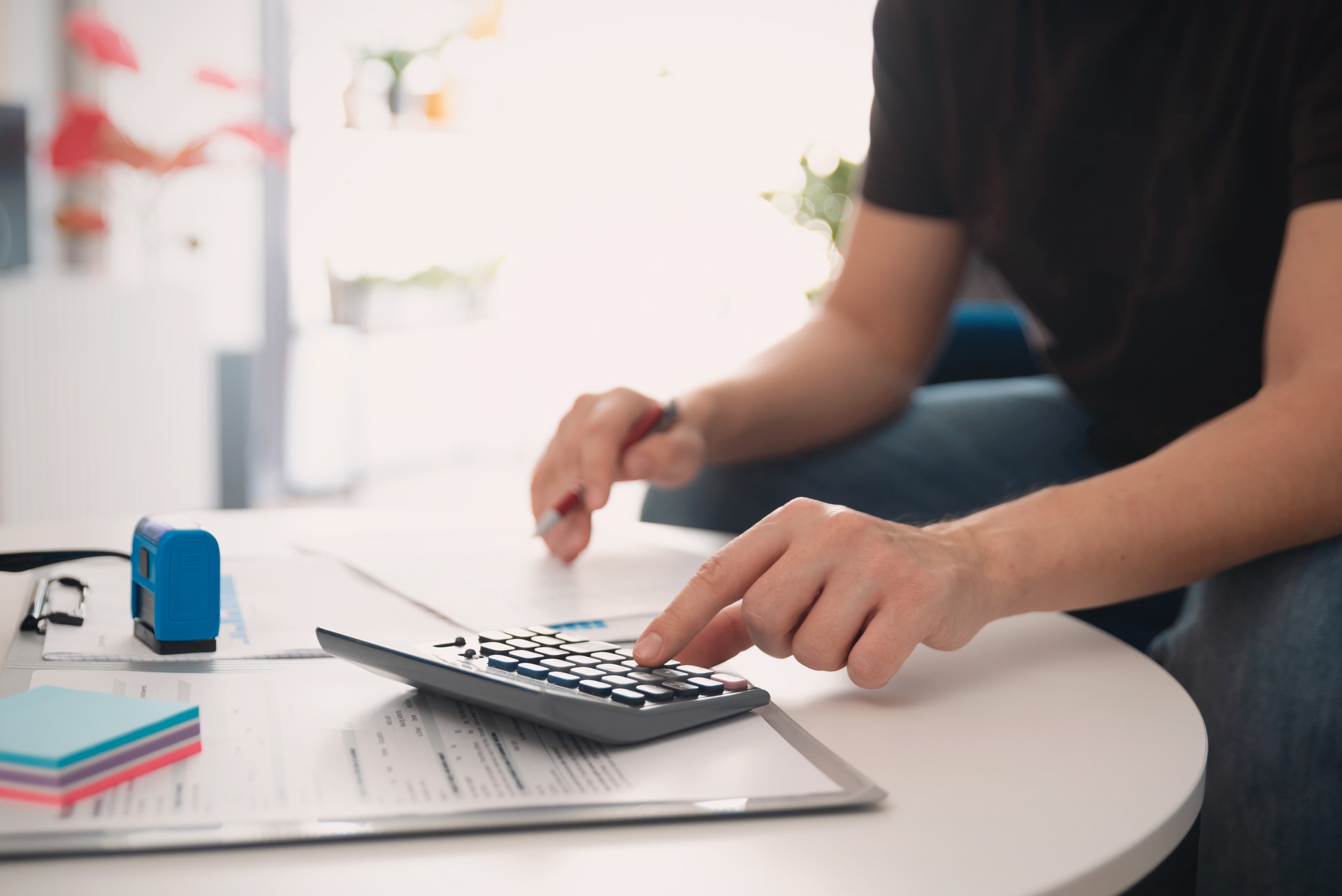 Business accounting concept, man using calculator.